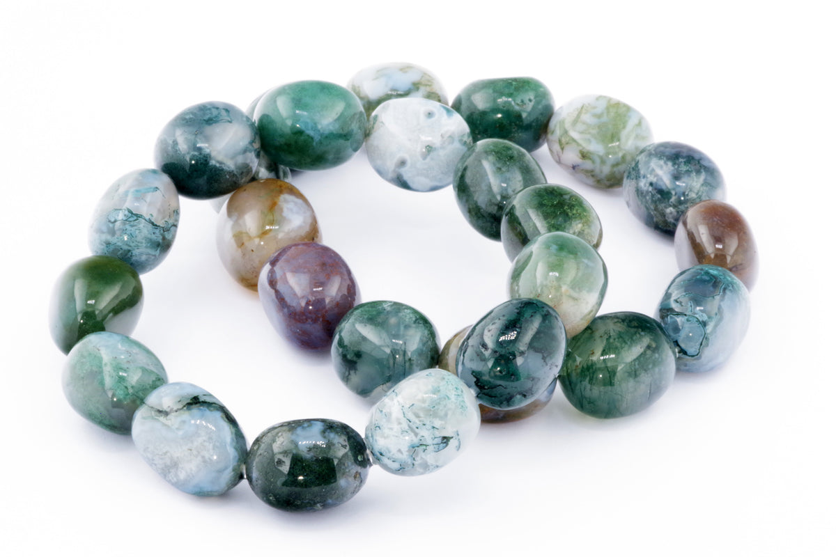 Close-up of polished natural crystal beads in varying shades of green and white arranged as a Moss agate bracelet – Gem, showcasing unique patterns and smooth texture.