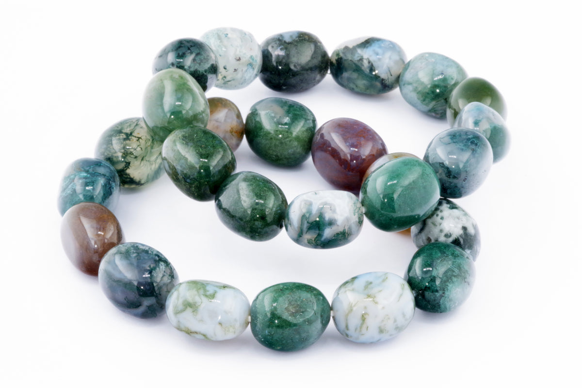Close-up of polished moss agate beads featuring green, white, and brown hues, arranged in a circular form representing the Moss agate bracelet – Gem.