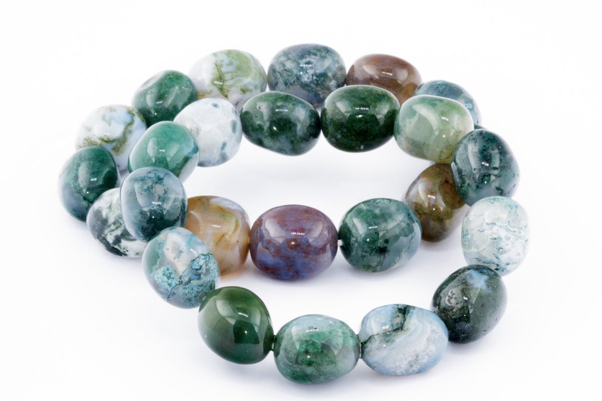 Close-up of a polished Moss agate bracelet – Gem featuring rounded beads in green, white, and brown hues, showcasing natural crystals and gemstone patterns.