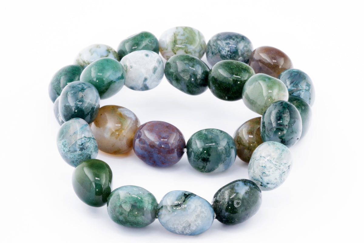 Close-up of a polished Moss agate bracelet – Gem featuring smooth, rounded stones in various shades of green, white, and brown, highlighting the natural crystal's unique patterns.