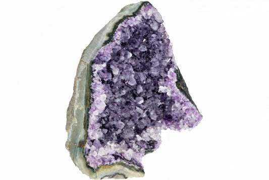 A geode slice with a rough grey-green outer rind and an interior cavity filled with purple and white amethyst crystals on a white background.