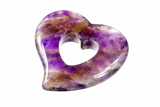 A polished heart-shaped pendant with a central hole, featuring purple and brown streaks on a white background.