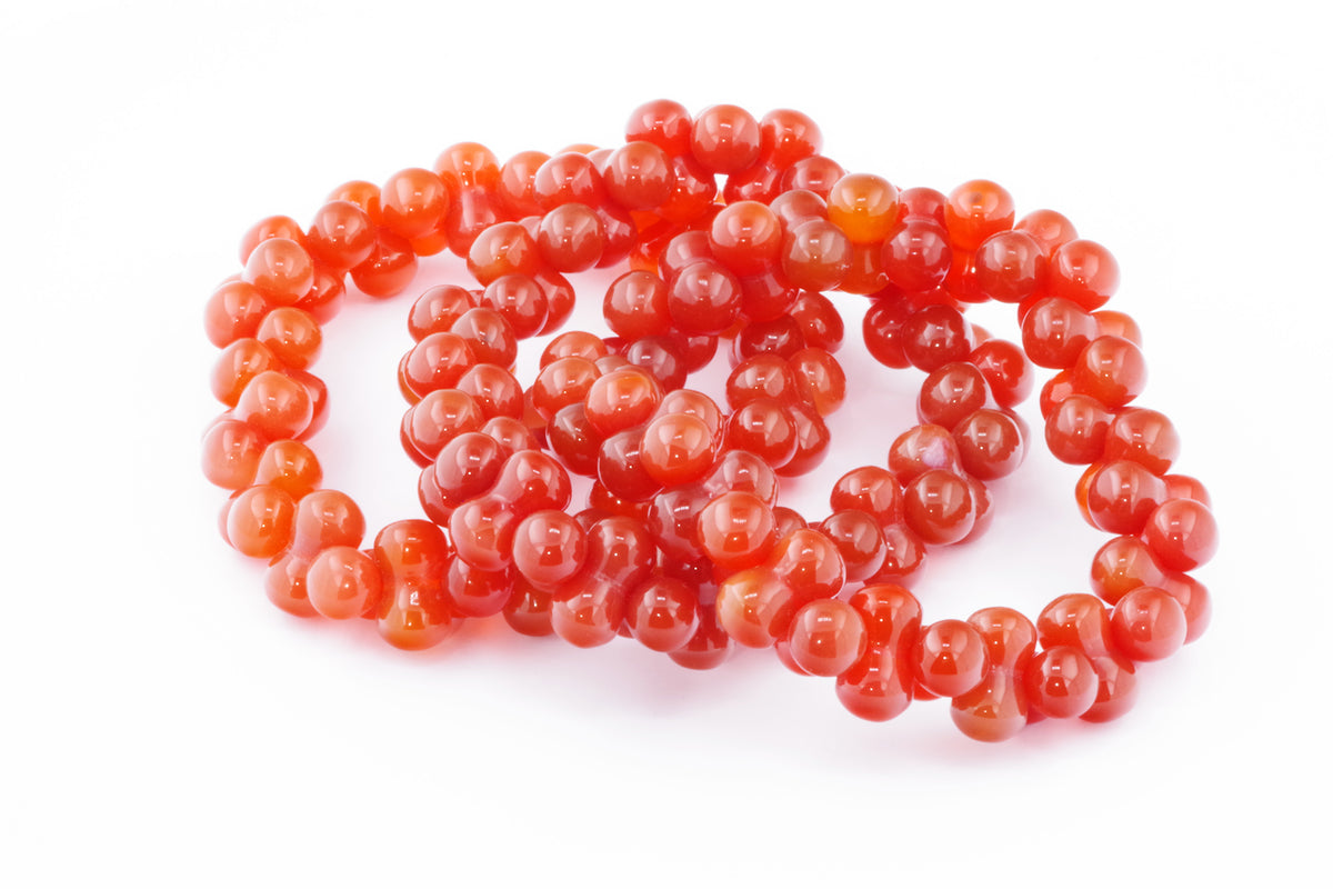 Carnelian bracelet – DNA featuring polished round carnelian gemstones in vibrant orange-red hues, designed as a radiant crystal bracelet for energy and grounding.