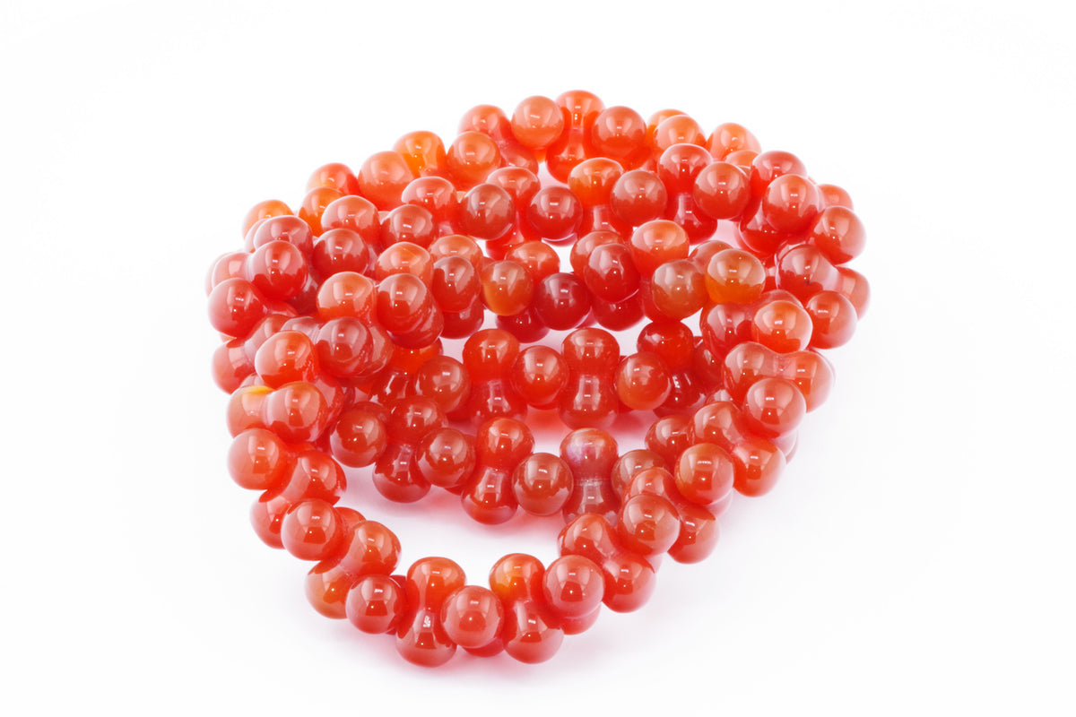 Carnelian bracelet – DNA made of polished natural carnelian crystal beads with a vibrant orange-red hue, designed as a stylish and healing crystal jewellery piece.