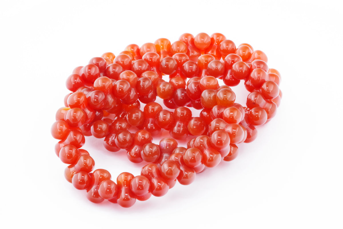 Carnelian bracelet – DNA featuring smooth, polished natural carnelian crystals in a linked bead design, showcasing vibrant orange-red hues and organic gemstone beauty.