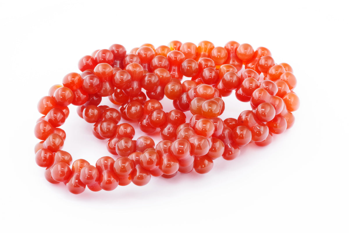 Carnelian bracelet – DNA featuring polished round natural crystals in vibrant orange-red hues, ideal as a crystal bracelet for energy, grounding, and healing purposes.