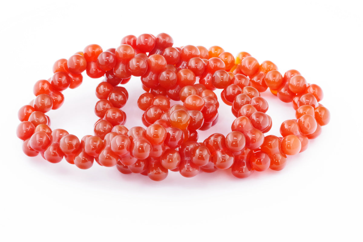 Carnelian bracelet – DNA featuring polished natural carnelian crystal beads in vibrant orange-red tones, designed for energy, grounding, and stylish crystal jewellery.