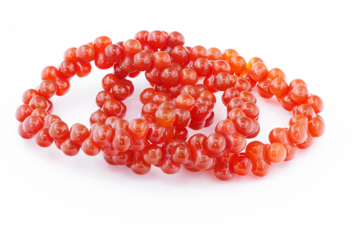 Carnelian bracelet – DNA featuring polished rich orange-red natural crystals arranged in an intricate double-helix inspired design for a unique crystal jewellery piece.