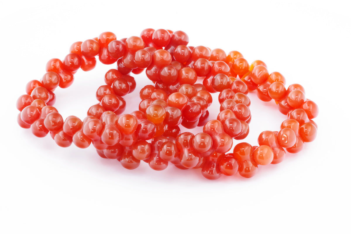 Carnelian bracelet – DNA featuring polished, rich orange-red natural carnelian gemstones strung in a unique DNA-inspired design, ideal for crystal jewellery enthusiasts.