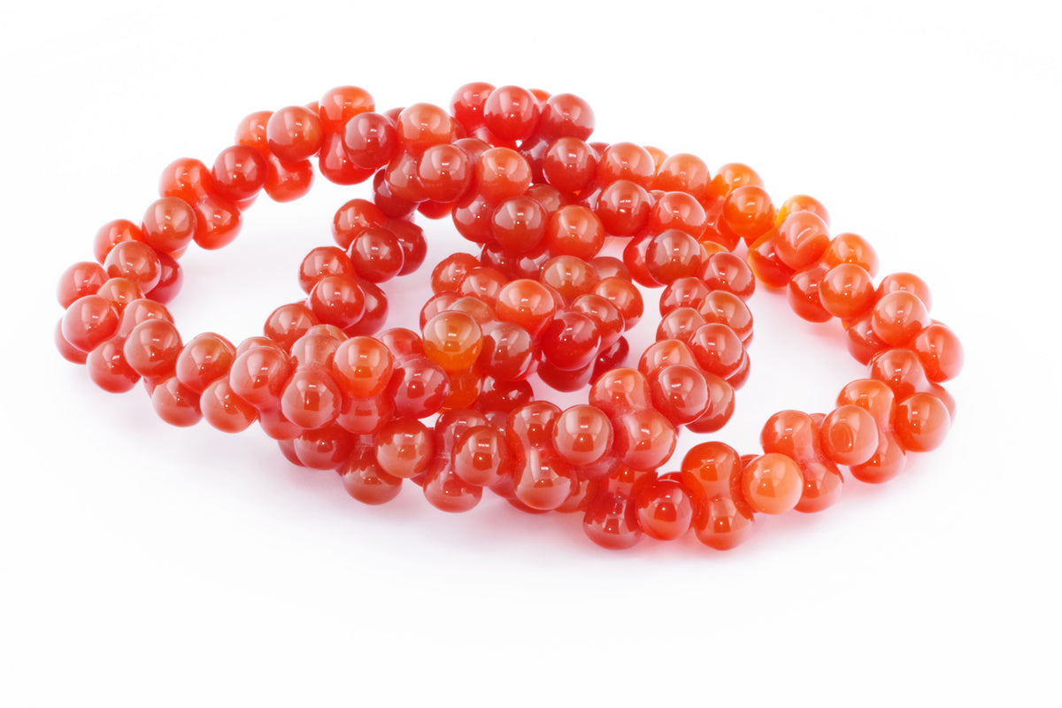 Carnelian bracelet – DNA made of polished natural carnelian gemstones, showcasing vibrant orange-red beads with a smooth, glossy finish, perfect for crystal jewellery lovers.