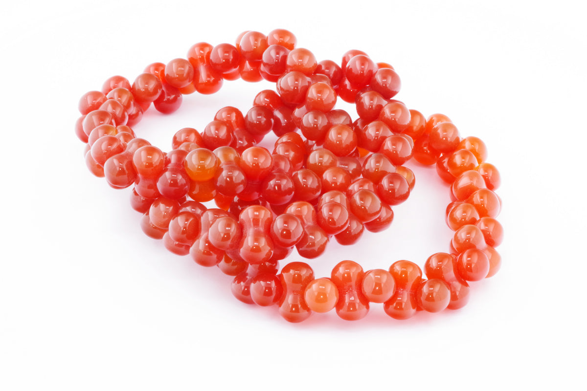 Carnelian bracelet – DNA featuring polished, vibrant orange-red carnelian beads shaped in a unique double helix-inspired design for crystal jewellery lovers.