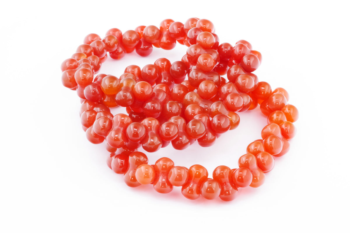 Carnelian bracelet – DNA featuring polished natural carnelian gemstones in a vibrant orange-red hue, arranged in a unique double helix-inspired design.