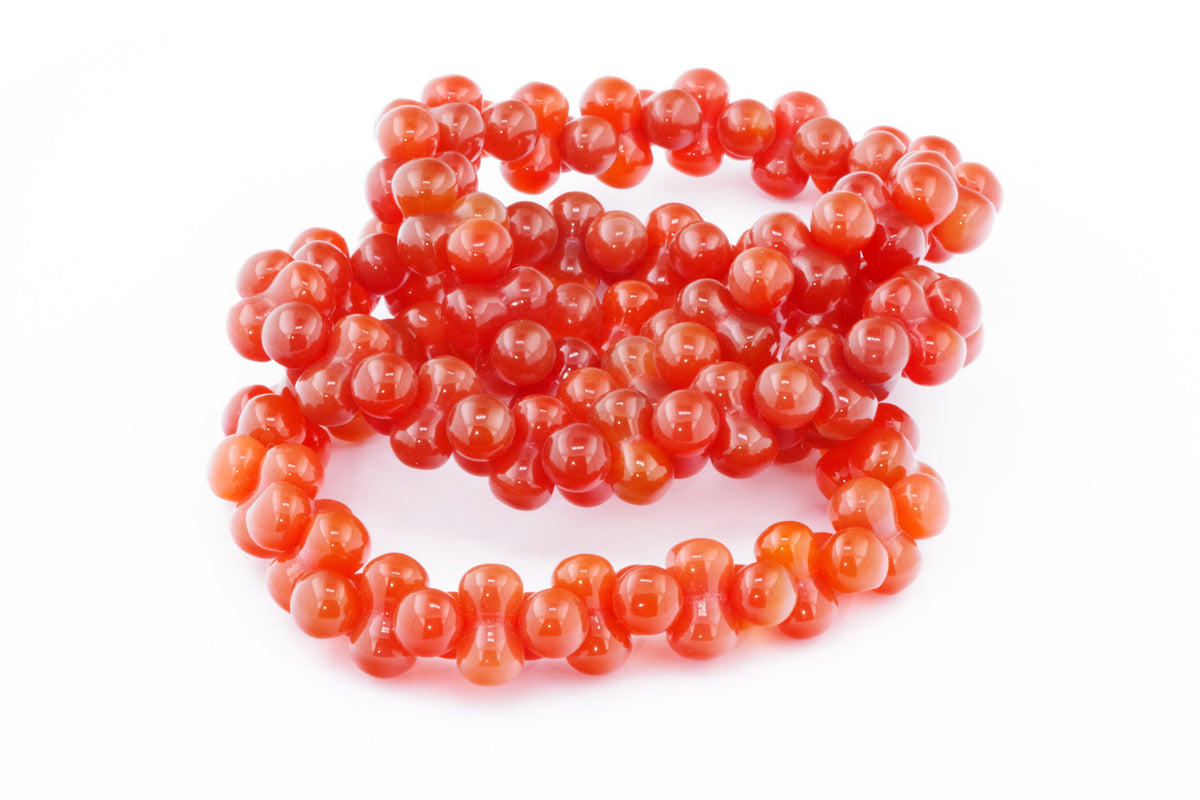 Carnelian bracelet – DNA featuring vibrant polished carnelian gemstones arranged in a unique, intricate beaded design, perfect as a natural crystal jewellery piece.