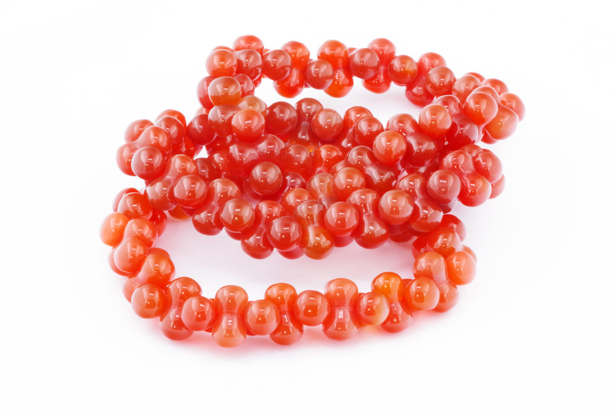 Carnelian bracelet – DNA featuring polished natural carnelian gemstones shaped into distinctive round beads, ideal for crystal jewellery and healing crystal collections.