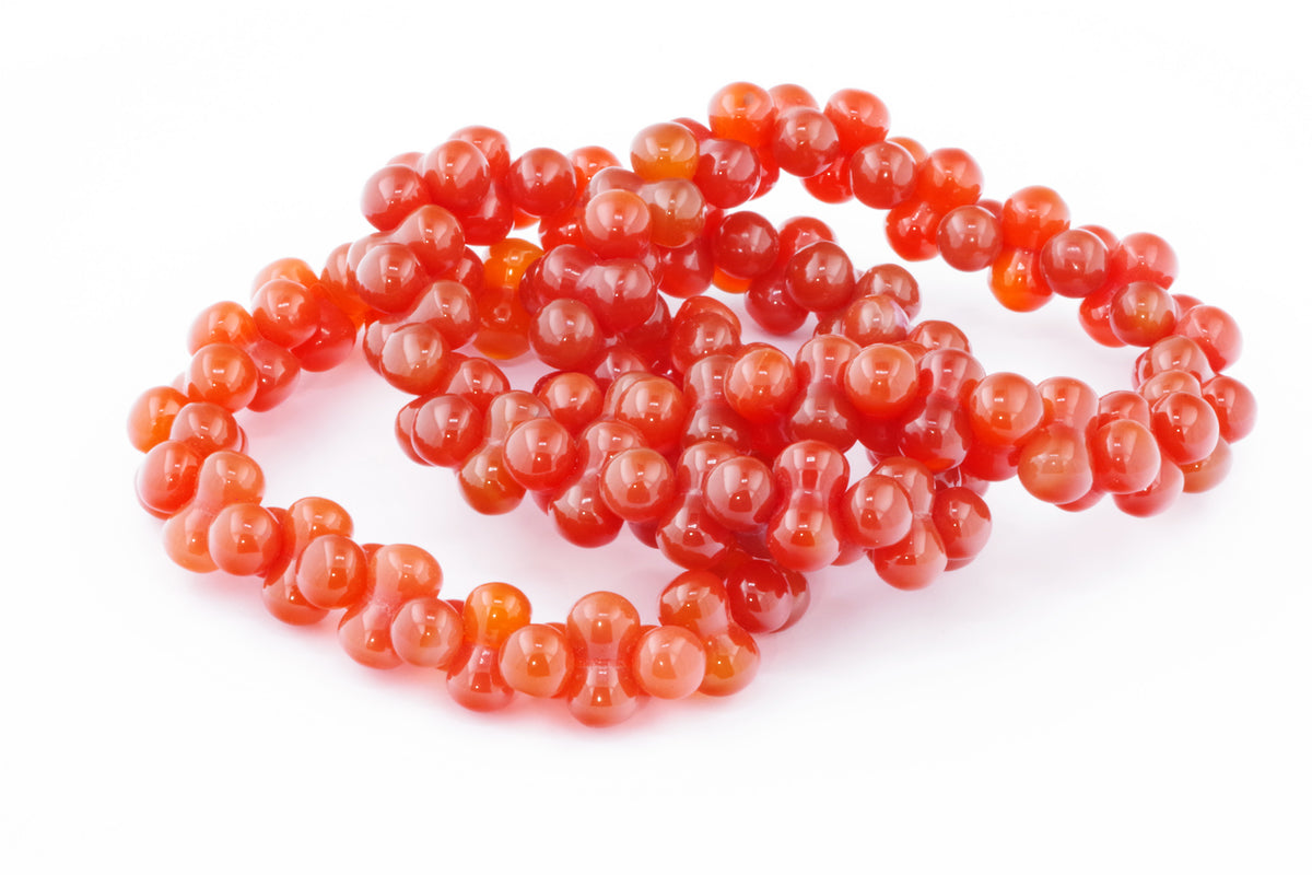 Carnelian bracelet – DNA featuring polished natural carnelian gemstones, showcasing vibrant orange-red crystal beads arranged in a unique, elegant design for crystal jewellery enthusiasts.