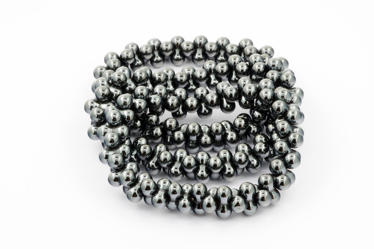 Hematite bracelet – DNA featuring polished natural hematite crystal beads arranged in a continuous strand, offering grounding and protective energy.