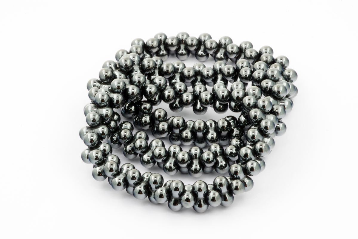 Hematite bracelet – DNA composed of polished dark metallic beads, showcasing natural hematite crystals known for grounding and protective properties in gemstone jewellery.