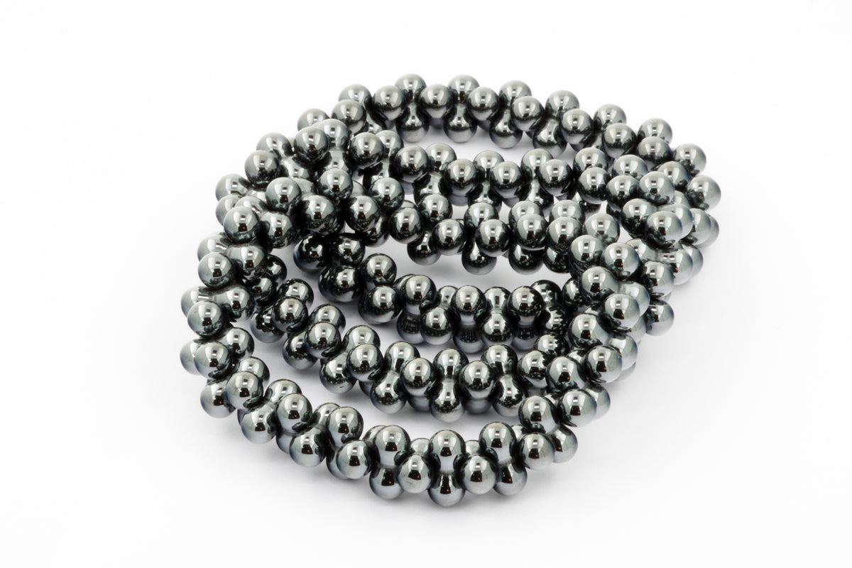 Hematite bracelet – DNA featuring polished hematite beads arranged in a continuous strand, showcasing its natural metallic gray luster and smooth texture.