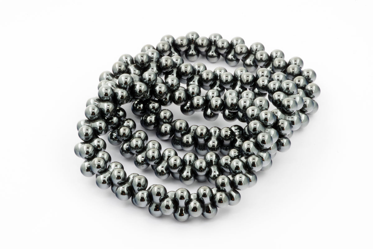 Hematite bracelet – DNA featuring polished dark metallic hematite beads arranged in a repeating double-helix inspired design, ideal as crystal jewellery for grounding and protection.
