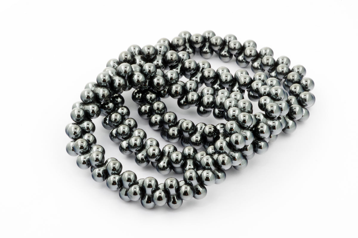 Hematite bracelet – DNA made of polished metallic grey hematite beads arranged in a smooth, reflective crystal bracelet pattern for healing and grounding.