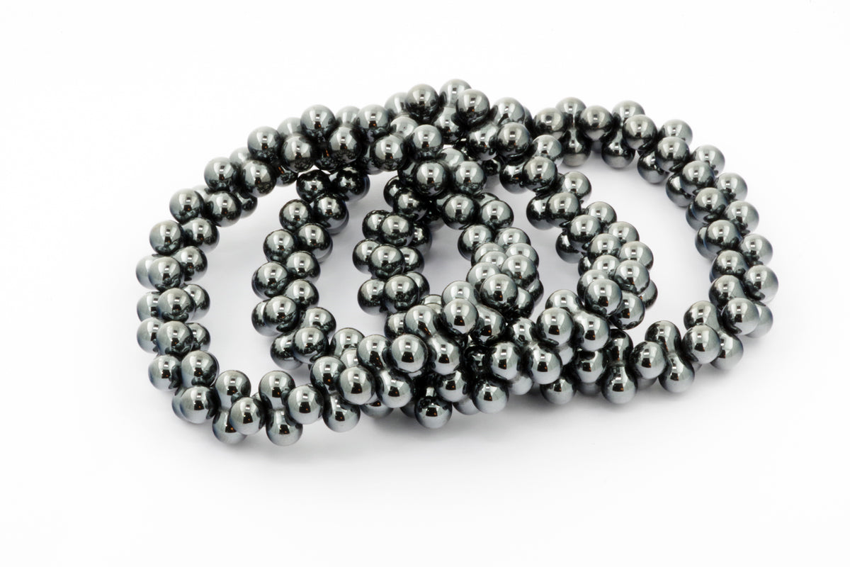 Hematite bracelet – DNA featuring polished dark gray hematite beads strung together, reflecting light with a smooth and shiny finish, ideal for crystal and gemstone jewelry lovers.