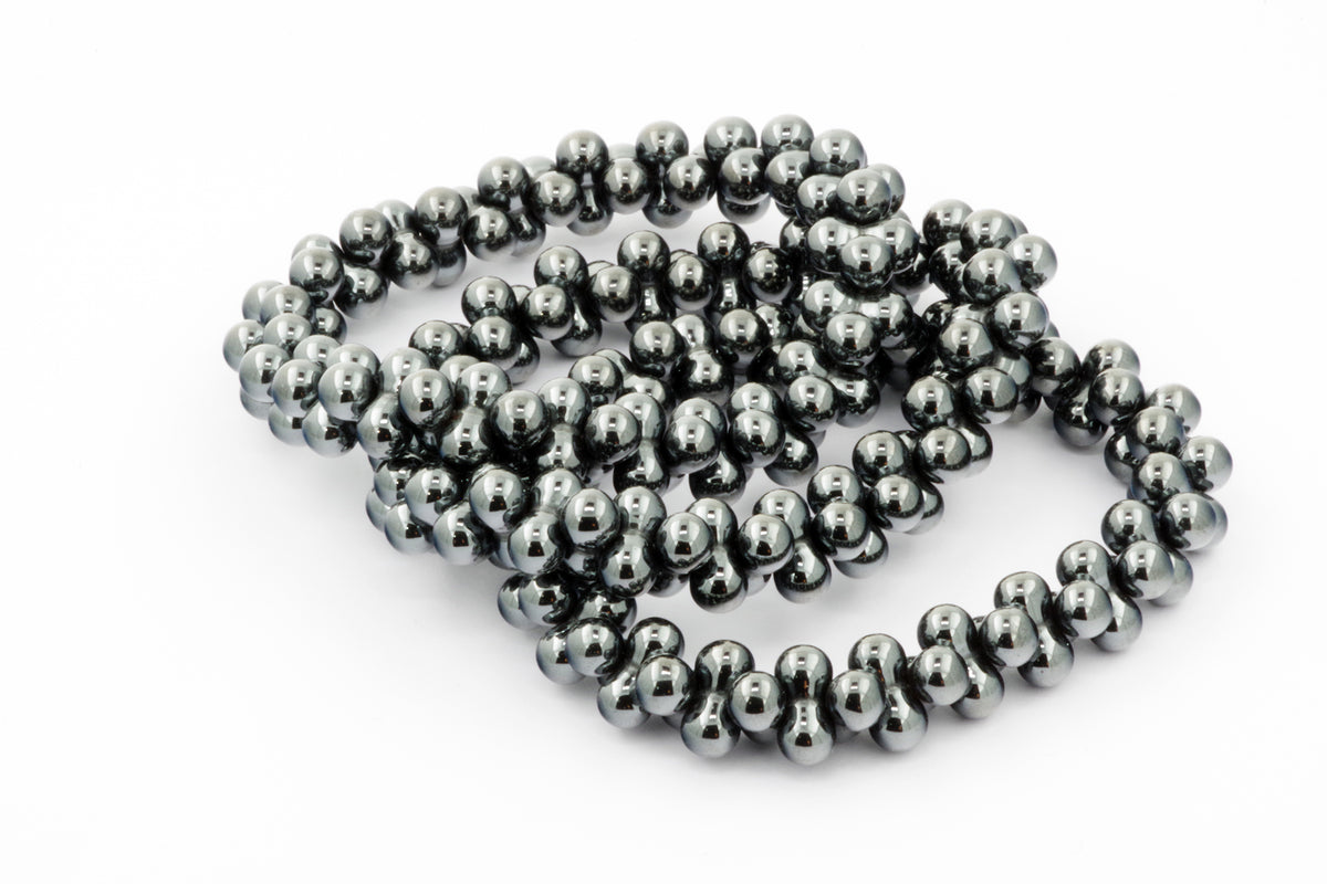 Hematite bracelet – DNA featuring polished hematite gemstone beads with a sleek, reflective surface, designed as a stylish crystal bracelet for grounding and energy healing.