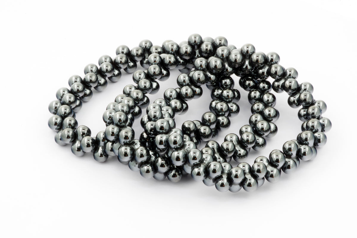 Hematite bracelet – DNA featuring polished dark metallic hematite beads strung closely together to form a sleek and grounding crystal bracelet accessory.