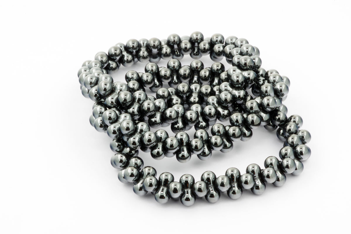 Hematite bracelet – DNA featuring polished, reflective hematite beads arranged in a unique linked design, showcasing natural crystal qualities and a modern crystal bracelet style.