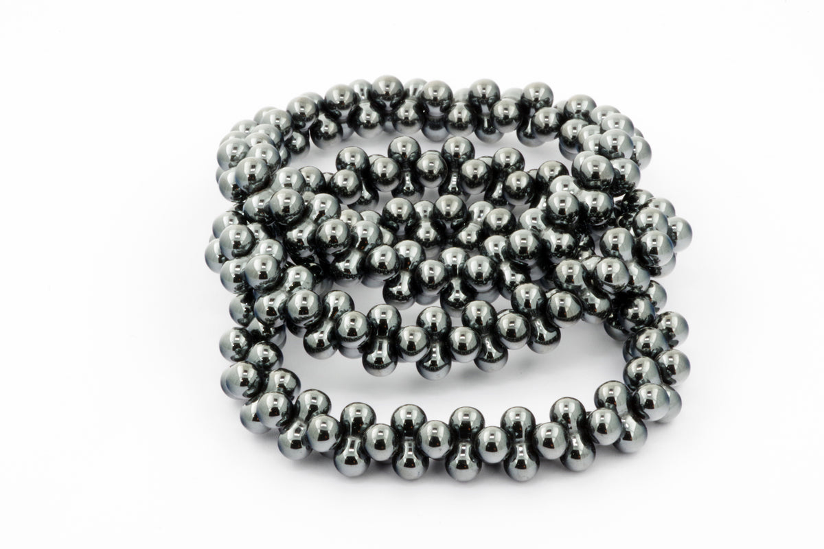 Hematite bracelet – DNA featuring polished hematite beads with a smooth, reflective surface, styled as a sleek crystal bracelet for grounding and energy healing.