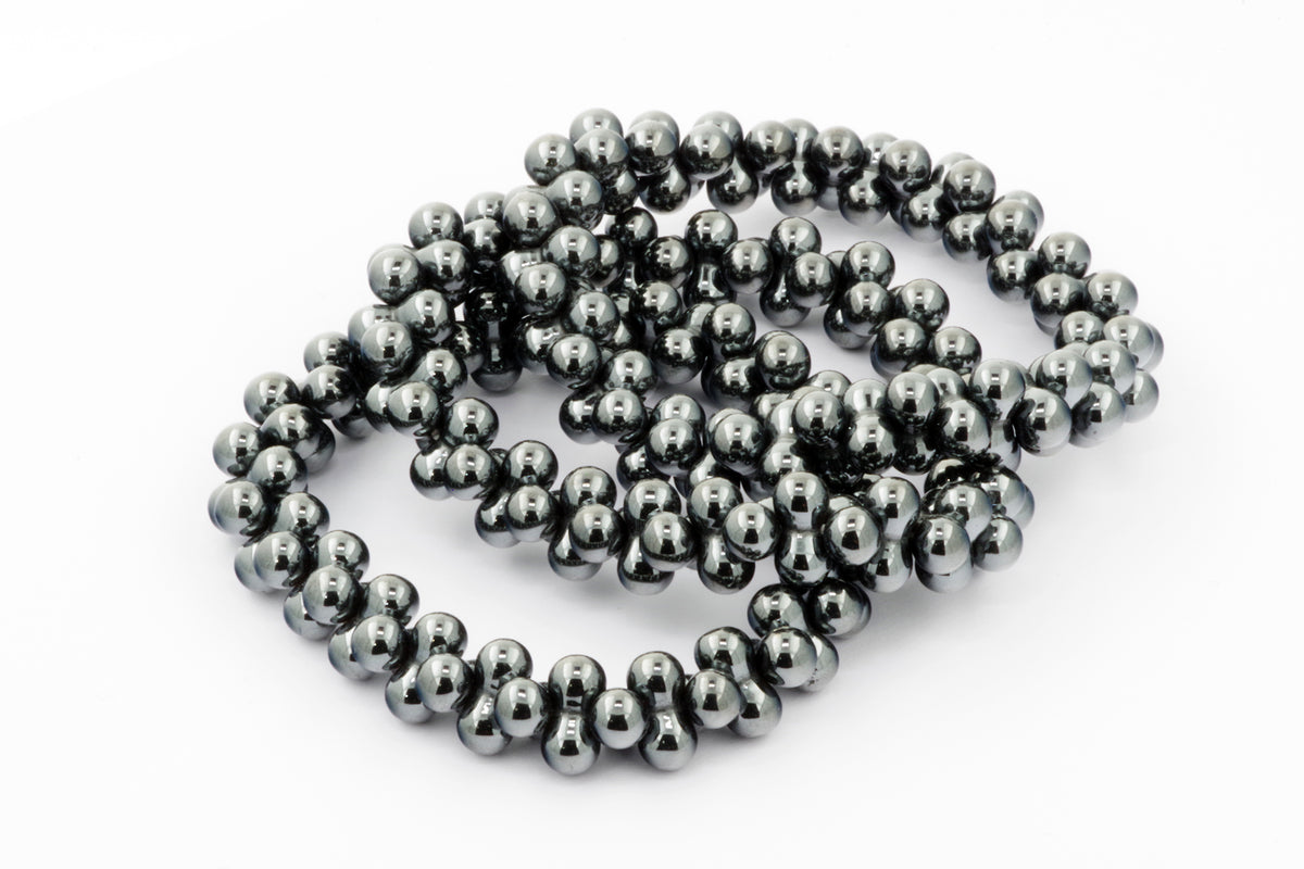Hematite bracelet – DNA featuring polished dark metallic beads elegantly arranged, showcasing natural crystals known for grounding and healing properties.