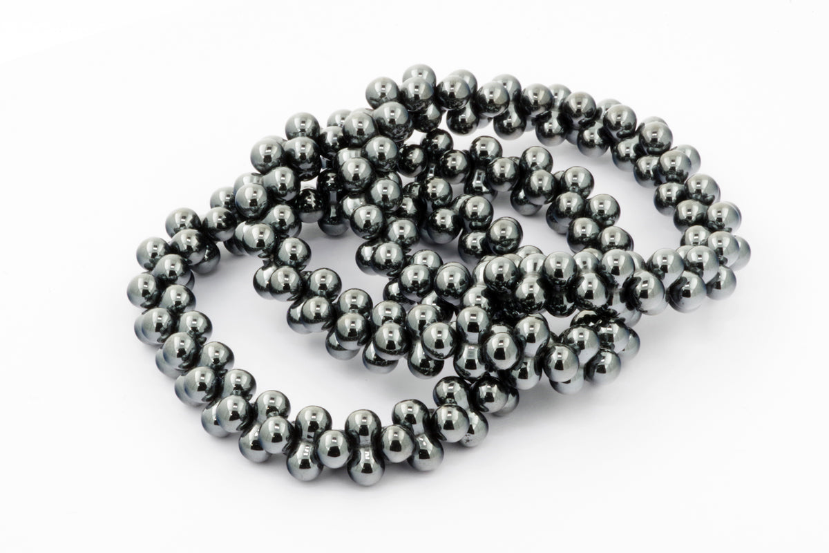 Hematite bracelet – DNA made of polished dark metallic hematite beads arranged in a stretchy strand, a sleek and grounding crystal bracelet.