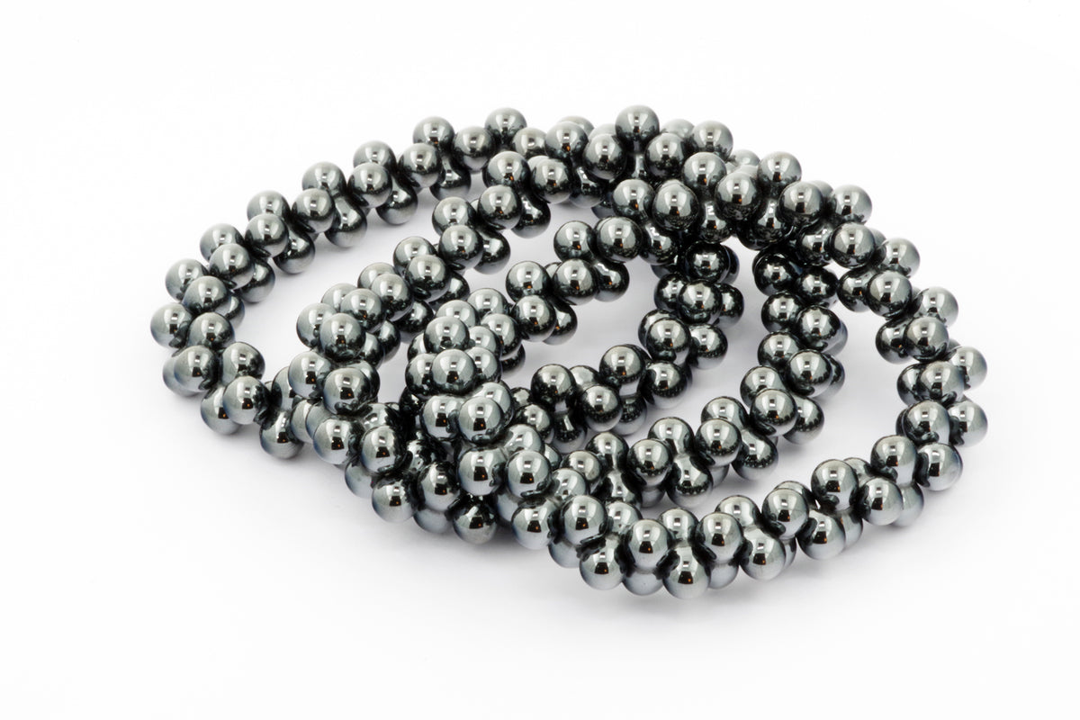 Hematite bracelet – DNA featuring polished dark metallic hematite beads strung into a reflective, elegant crystal bracelet designed for grounding and energy balance.