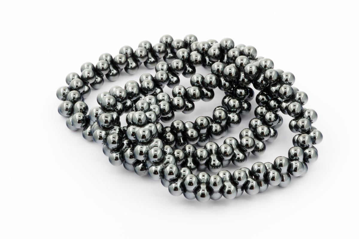 Hematite bracelet – DNA featuring smooth, polished natural hematite beads arranged in an elegant, reflective design, ideal as a crystal bracelet for grounding and healing.