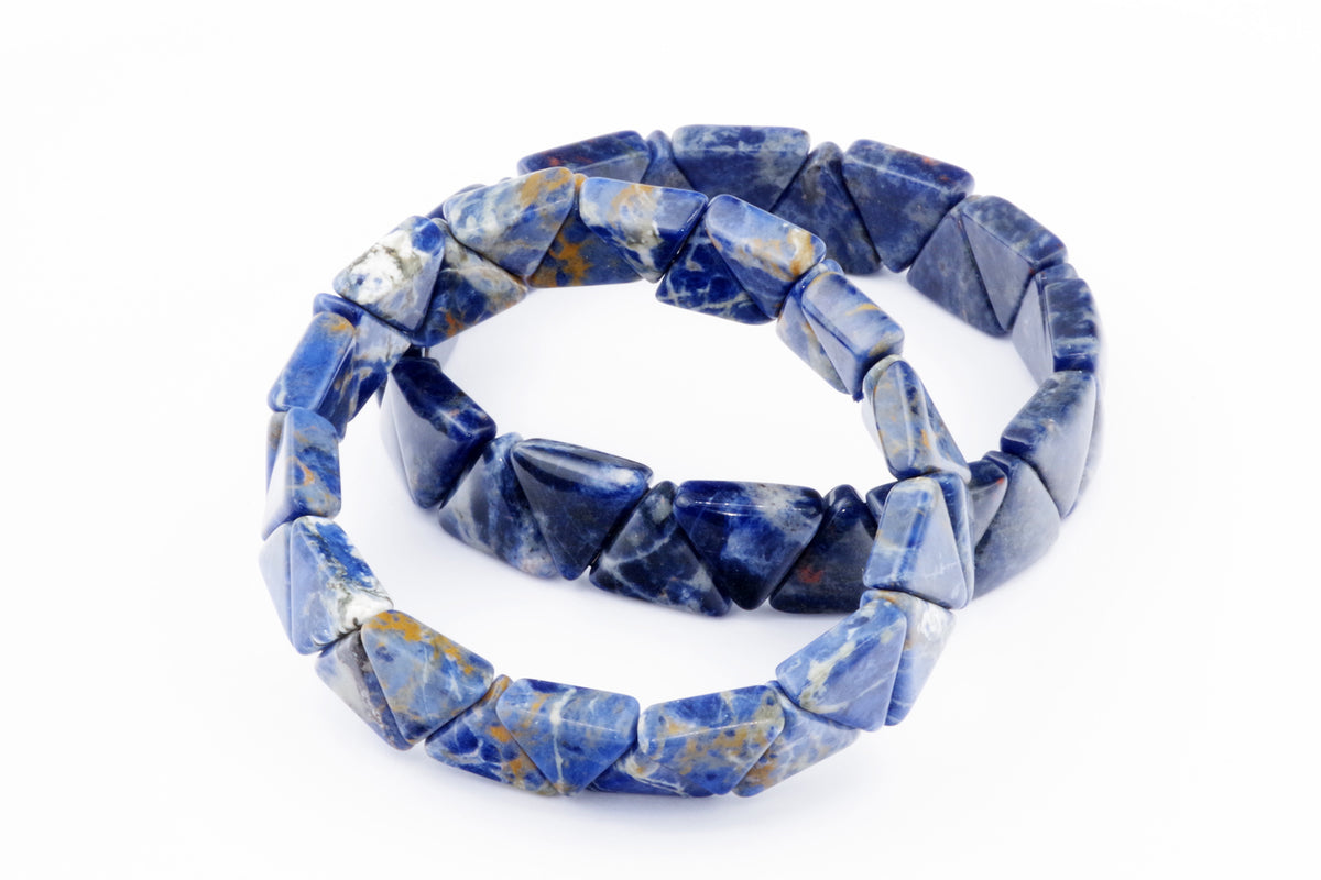 Two bracelets made of polished blue sodalite gemstones shaped into triangles, arranged on a white background as a Sodalite bracelet – Triangle.