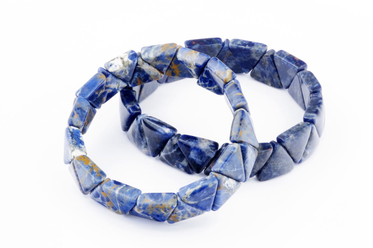 Two blue sodalite crystal bracelets featuring polished triangular beads, shown on a white background, highlighting natural gemstone patterns and textures in the Sodalite bracelet – Triangle design.