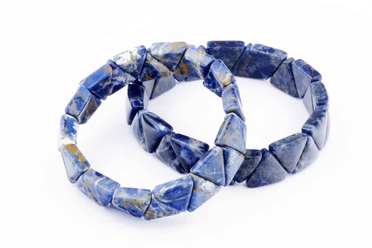 Two sodalite bracelets – Triangle featuring polished blue and white natural crystal gemstones arranged in triangular shapes on a white background.