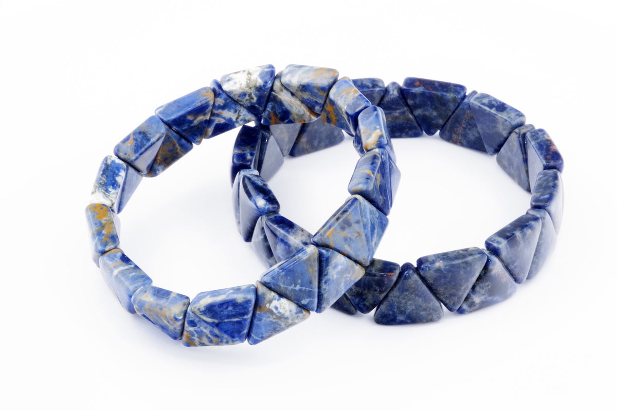 Two Sodalite bracelet – Triangle pieces featuring polished blue natural crystal gemstones arranged in triangular shapes against a white background.