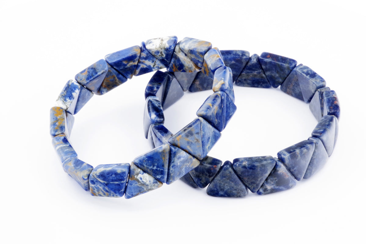 Two Sodalite bracelet – Triangle pieces featuring polished blue and white natural crystal gemstones arranged in triangular shapes on a white background.