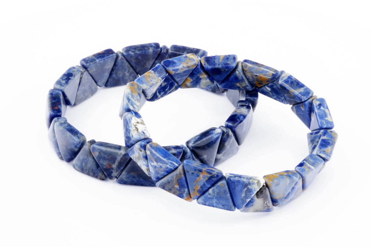 Two blue gemstone crystal bracelets made with triangular sodalite beads arranged in a circle, known as Sodalite bracelet – Triangle, displayed on a white background.