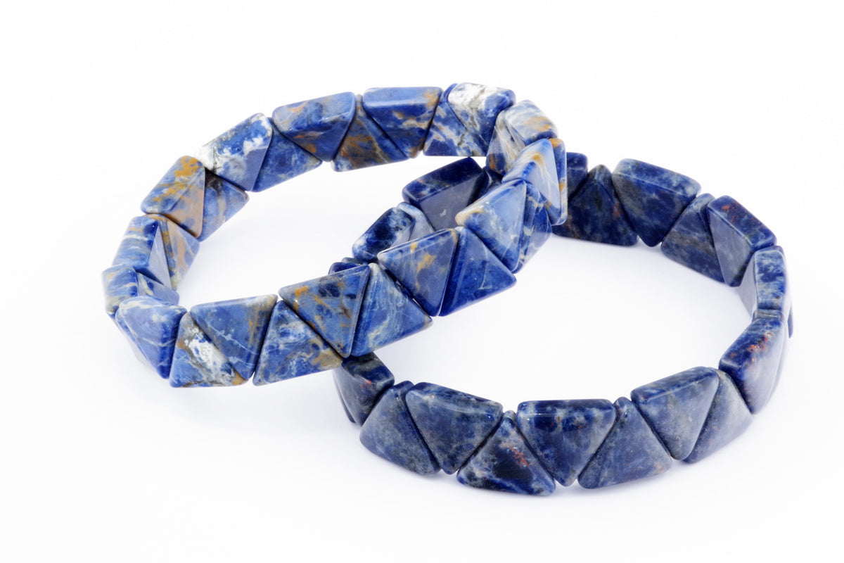 Two crystal bracelets made of natural blue sodalite gemstone beads in triangular shapes, showcasing the Sodalite bracelet – Triangle design on a white background.