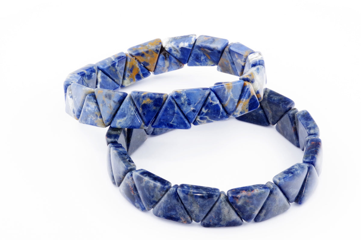 Two crystal bracelets made of polished blue sodalite gemstones shaped into triangles, showcasing natural mineral patterns and deep blue hues in the Sodalite bracelet – Triangle style.