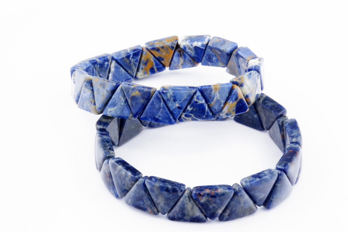 Two natural crystal Sodalite bracelet – Triangle designs featuring polished blue gemstones with white and brown mineral patterns, styled as delicate crystal bracelets for healing and meditation.