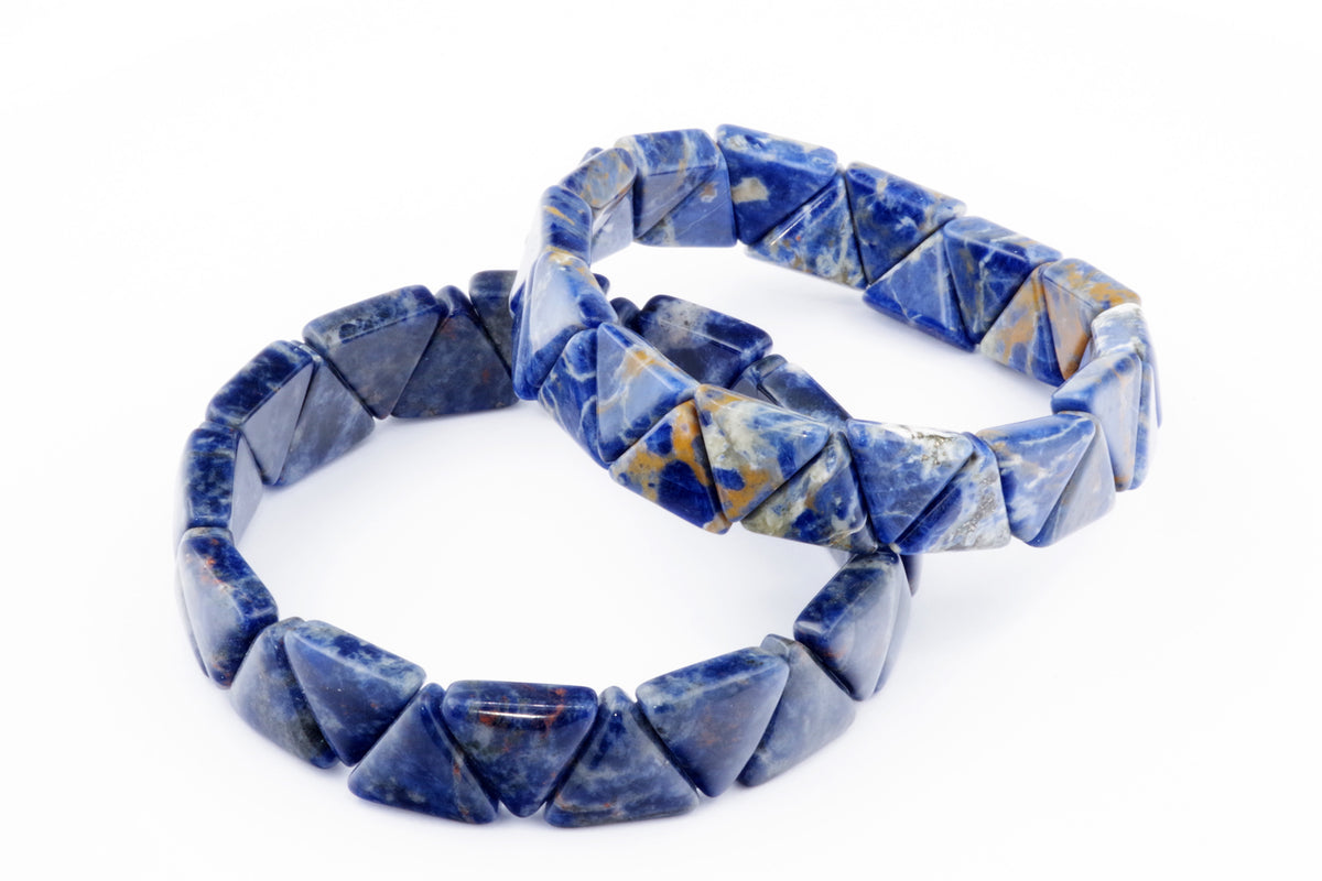 Two natural crystal gemstone Sodalite bracelet – Triangle designs with polished blue and white triangular stones arranged on elastic bands.