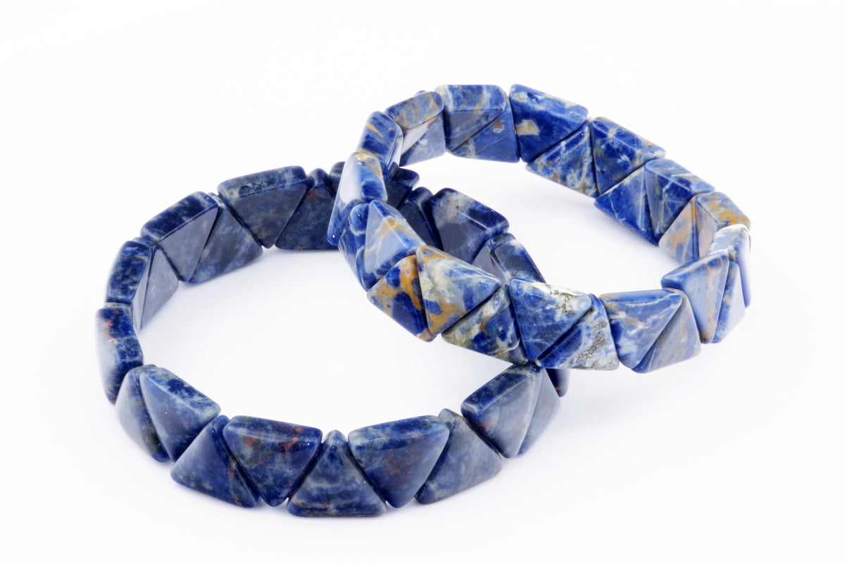 Two Sodalite bracelet – Triangle pieces featuring deep blue polished natural crystals with white and orange mineral veins, arranged on a white background.