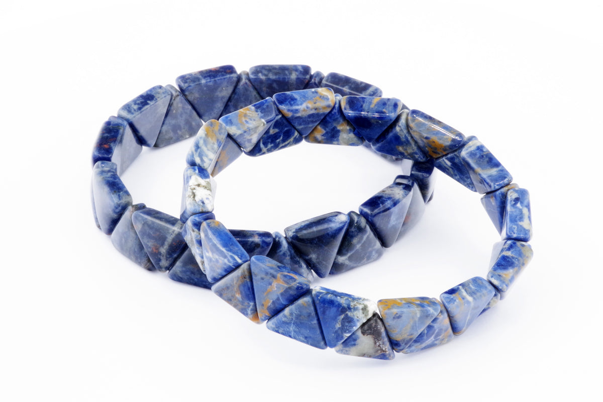 Blue and white triangular sodalite beads strung together forming a geometric crystal jewellery piece named Sodalite bracelet – Triangle, showcasing natural gemstone patterns.