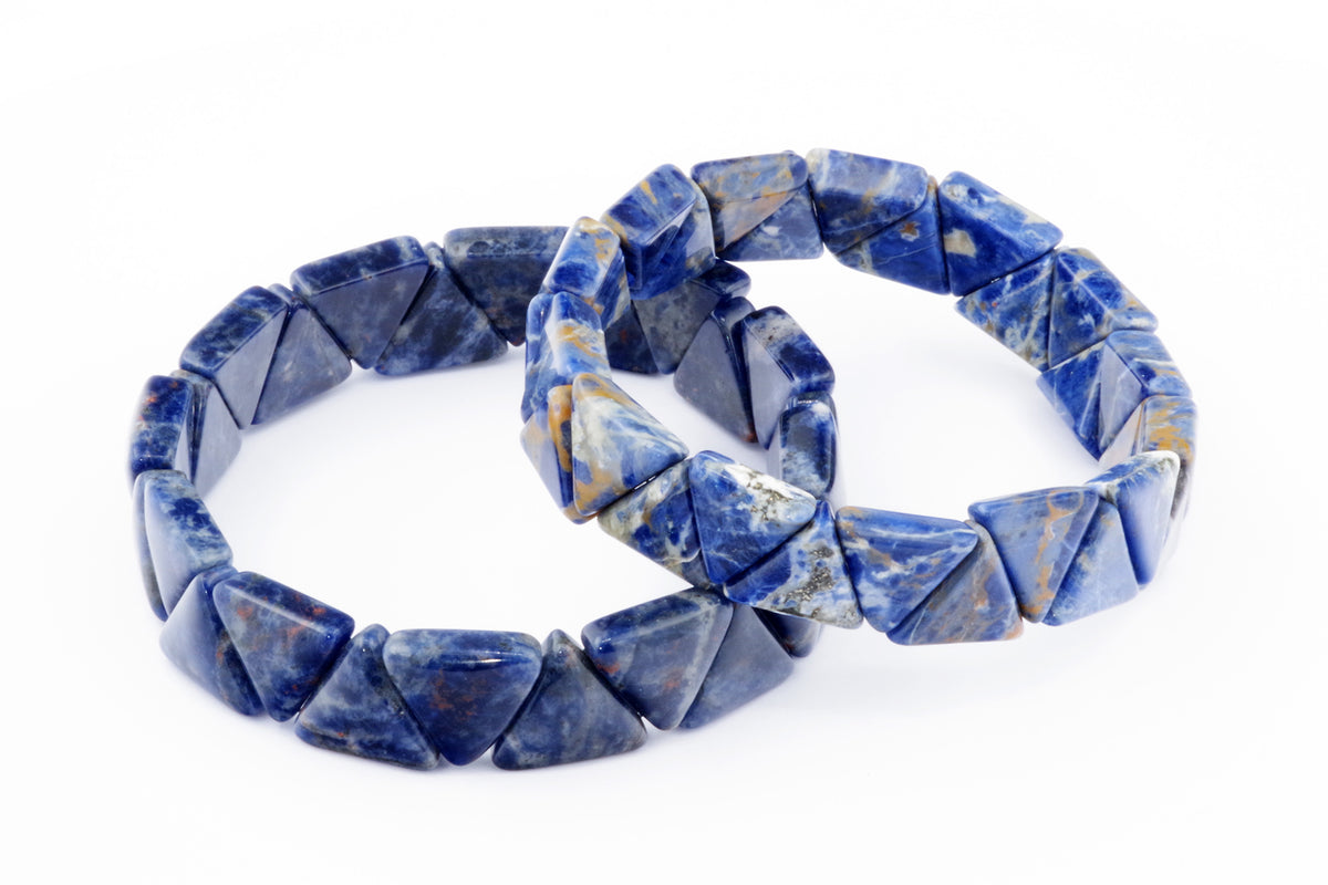 Two Sodalite bracelet – Triangle featuring polished blue natural crystals with white and tan mineral patterns arranged on a white background.