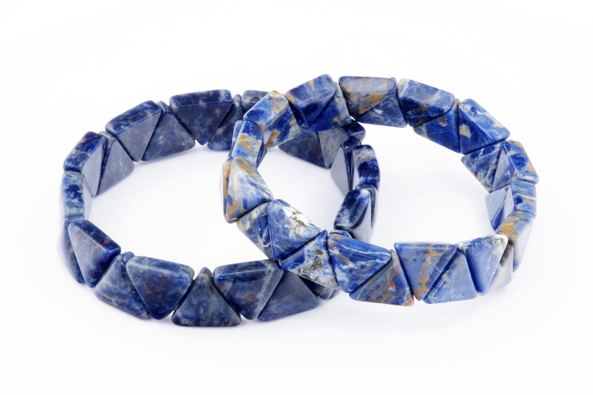 Two blue Sodalite bracelets – Triangle shaped polished natural crystal gemstones arranged in a circular band on a white background.