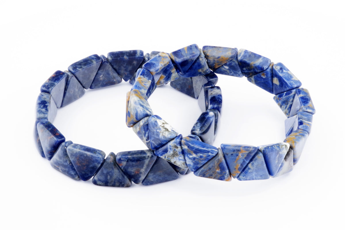 Two polished blue sodalite crystal bracelets composed of triangular beads, showcasing natural variations and a smooth finish, labeled as Sodalite bracelet – Triangle.