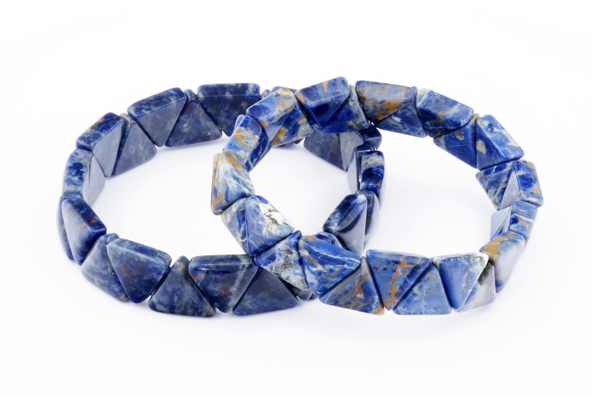 Two sodalite gemstone bracelets composed of polished blue triangular beads arranged in a continuous loop, showcasing natural crystal patterns and shades of blue and white, Sodalite bracelet – Triangle.