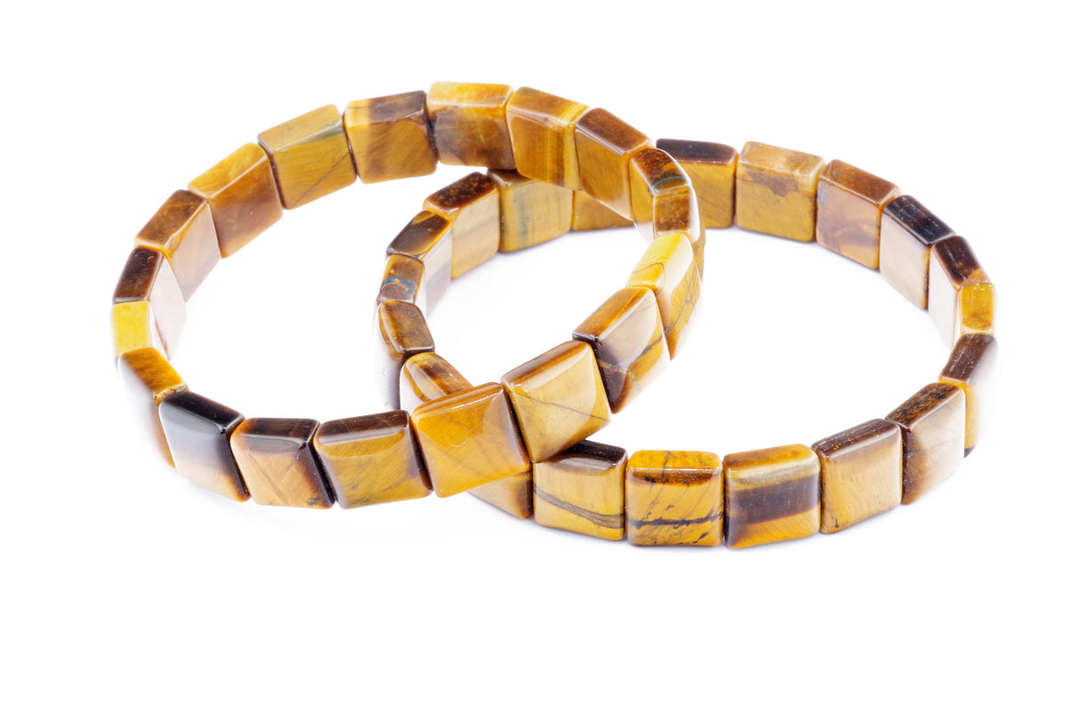 Two polished Tiger eye bracelet – Square pieces featuring natural golden-brown crystal gemstones with characteristic chatoyancy, arranged on a white background.